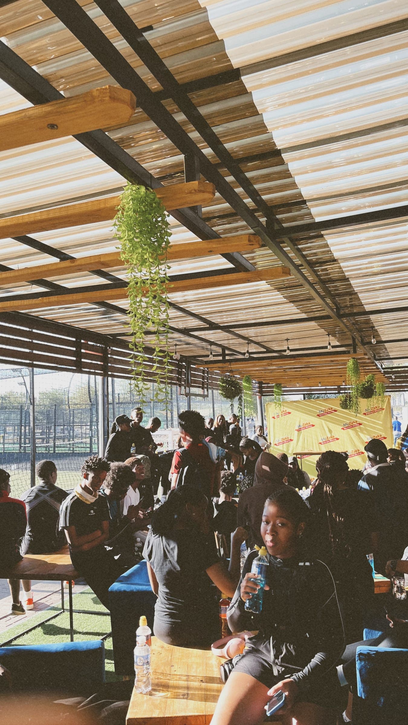 Members resting with water under the clubhouse pergola after a run